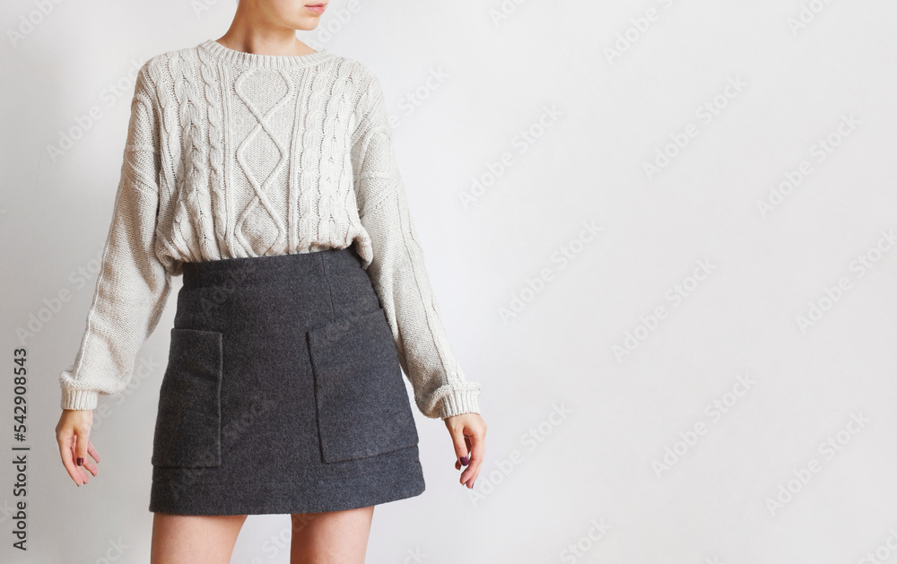 Sticker Woman wearing oversized white sweater and woolen mini skirt isolated on white background