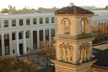 Late afternoon sun shines on the historic church and downtown of the bay area city of Alameda,...