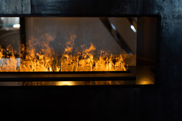 stylish artificial fireplace behind glass