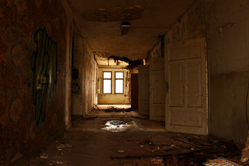 Lost Place, old House, abandoned hallway with open doors in a rotten surrounding