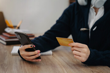 Closeup women holding hand credit card.businessman use smartphone online payments shopping in the morning.