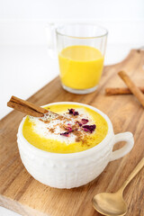 Golden milk with vegetable or cow's milk and with turmeric, cinnamon and other spices. Very aromatic, healthy and tasty drink.