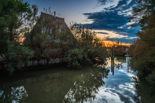 Towards the sunset. Marano lagoon late summer colors. Clouds and sun