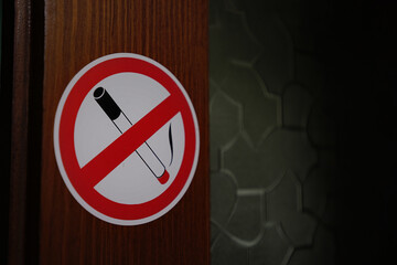 No smoking prohibition circle sign in red frame fixed on wall indoor. No smoking concept.