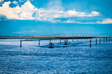 Obraz premium Towards the sunset. Marano lagoon late summer colors. Clouds and sun
