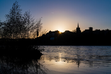 Sunset skyline at “Hakortsee“ an artificial lake of Ruhr River in Wetter Germany. Silhouettes...