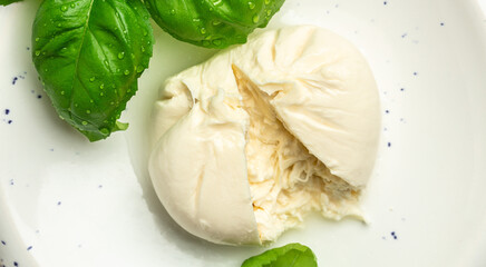 fresh soft white burrata cheese ball made from mozzarella and cream from Apulia, Italian...