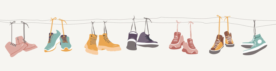 Collection of shoes hanging on shoelaces. - obrazy, fototapety, plakaty