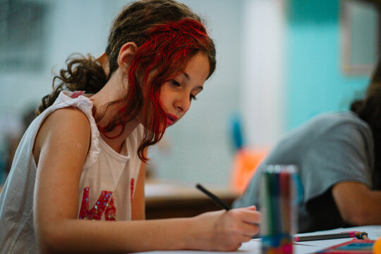 Portrait Of Student Girl Writing