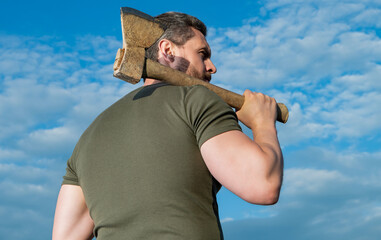 back view of man with axe. lumberjack man hold ax. brutal man on sky background