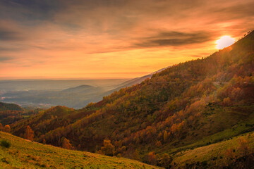 Beautiful sunset over the autumnal foliage of the Biella Mountains, Piedmont,  Italy