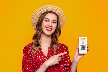 young woman holding a mobile phone with a discount coupon and a qr code