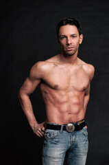 Fototapeta premium Young attractive guy posing in the studio. Beautiful body.