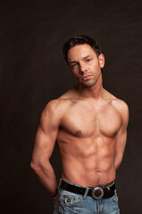 Fototapeta premium Young attractive guy posing in the studio. Beautiful body.