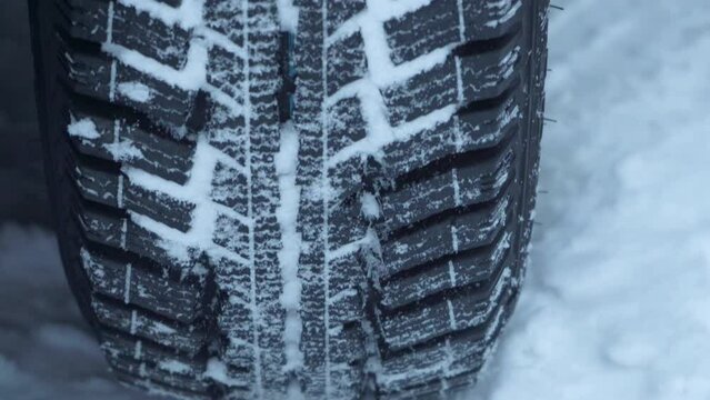 car wheel in winter close-up,new tires on a car in winter, a car wheel in the snow