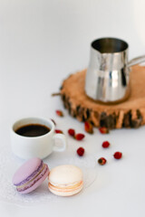 Obraz na płótnie Canvas cup of coffee with macaroon and flowers