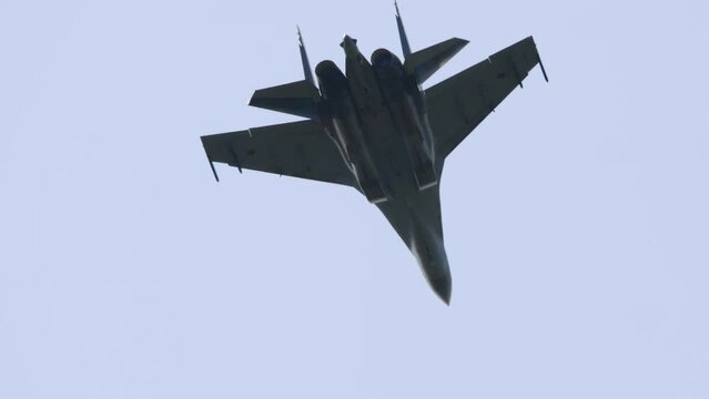 Russian jet military aircraft Flanker-E at airshow. Fighting falcon. Fighter aircraft perform extreme stunts in the sky at airshow. Su-35 Russian multi-role super-maneuverable fighter