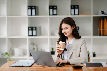 Working woman concept a female manager attending video conference and holding tablet, smatrphone and  cup of coffee