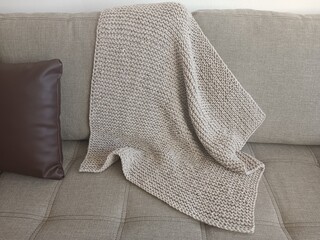 Knitted blanket on the sofa