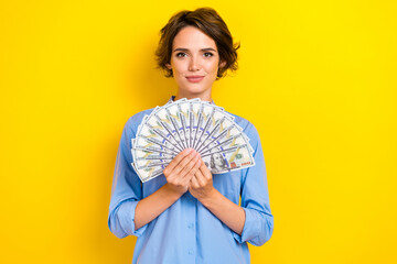 Photo of gorgeous cheerful cute girl with bob hairdo dressed blue shirt hands hold dollars money...