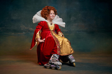 Portrait of little red-headed girl, child in costume of royal person in rollers isolated over dark green background