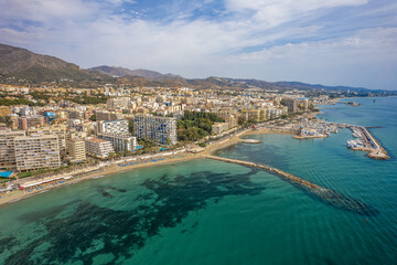 The drone aerial view of the beach and downtown district of Marbella,  Spain.Marbella is a city and municipality in southern Spain, belonging to the province of Málaga. - obrazy, fototapety, plakaty