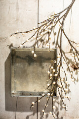 Vintage metal box with white berries on white wood surface