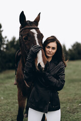 Fototapeta premium A young woman and friendship with a horse.