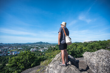 Asian fat man stand on the rock  at Khao hin lek fai view point.Khao Hin Lek Fai is a place to see...