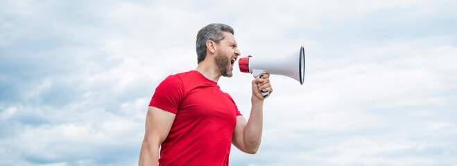 man in red shirt shout in loudspeaker on sky background. promotion