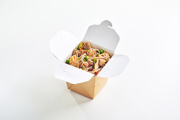 Wok with turkey meat, Soba noodles, paprika, mushrooms and carrot in take-out box