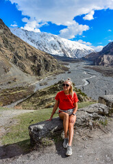 A young girl on the background of the Darial gorge, Kazbegi district, Mtskheta-Mtianeti region, Georgia 2019.