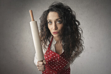 portrait of woman with rolling pin in hand - obrazy, fototapety, plakaty