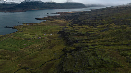 icelandic  mountains covered with snow with a bay in fjords