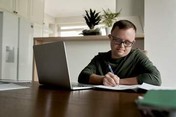 Man with down syndrome learning at home