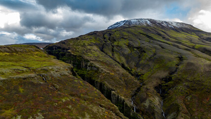  Glymur Waterfall canyon with  Hvalfell mountain peak covered with snow