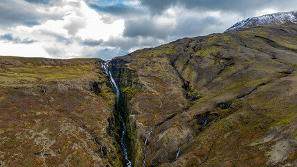  Glymur Waterfall canyon with  Hvalfell mountain peak covered with snow