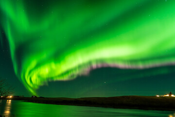 bright aurora borealis northern light over water