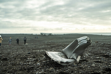 part from dc 3 plane wreck on black beach with tourists