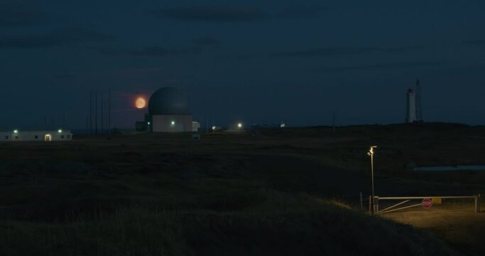 Moonrise over Nato Listening station Stokksnes Iceland access gate