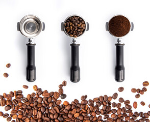 Brown roasted coffee beans and powder on the potta filter isolated on white background.