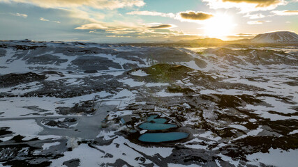 aerial view of Myvatn Nature Baths hot spring with landscape covered with snow during sunrise