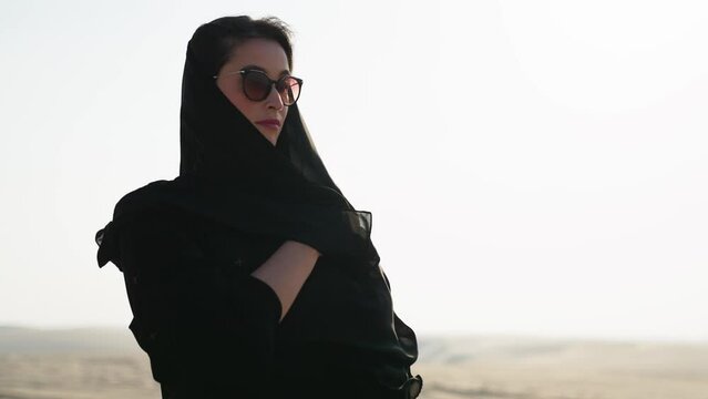 Portrait of beautiful young Arab muslim woman in traditional black hijab. At Doha Qatar. Close up of female. Arabian headscarf. Outdoor.
