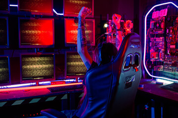 Winning. Young woman in gaming headphones playing video game online at home neon room feel excited, Happy Gamer young plays online video games computer she raises hands to wins tournament, E-Sport