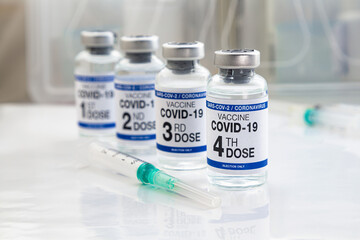 Coronavirus vaccine tagged first, second, Third and fourth dose of vaccine on the label. COVID-19...