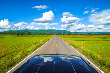 Beautiful farmland view from the roof of a pickup truck driving on the country road on a sunny day, Neon Maprang district, Phitsanulok, Thailand - obrazy, fototapety, plakaty