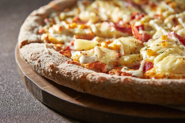 Bacon Potato Cheese Pizza on a Cutting Board