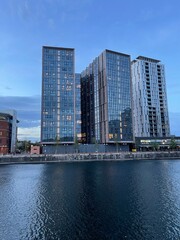 Obraz premium Modern buildings by the waterfront at twilight. Taken in Salford Quays England. 