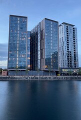 Fototapeta na wymiar Modern buildings by the waterfront at twilight. Taken in Salford Quays England. 