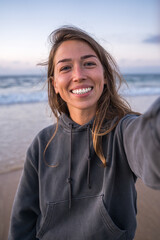 Pov of the smiling brunette girl looking at the camera while standing at the ocean beach - 542993711